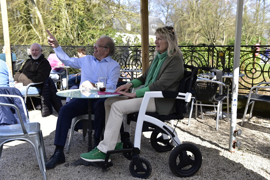 about-02 Elderly couple enjoying being outside with a wheelchair.