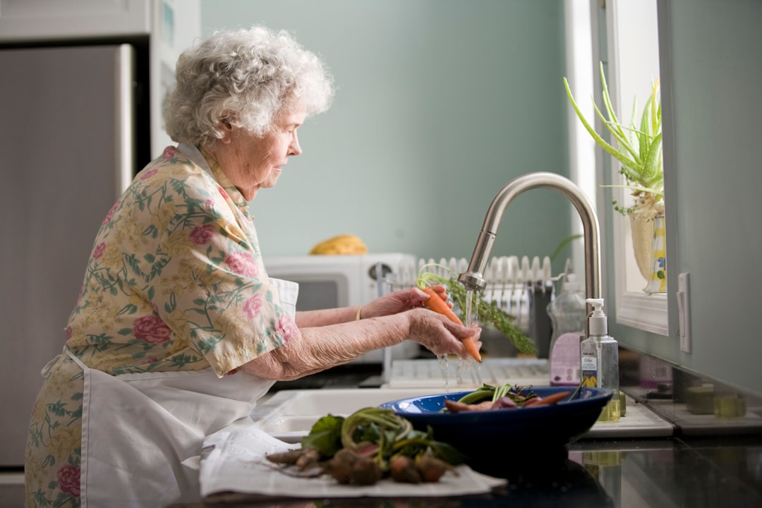 services-04 Elderly woman cleaning vegetables. Photo by Cade Martin